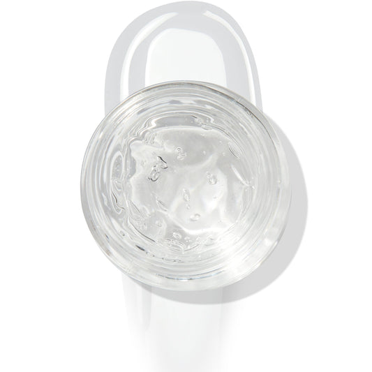 In The Clear Face & Eye Gloss in an open round jar gleams with a glossy swipe beneath it on a white background, showcasing the ColourPop Face & Eye Gloss for dewy, glass-skin shine on lids and cheeks.